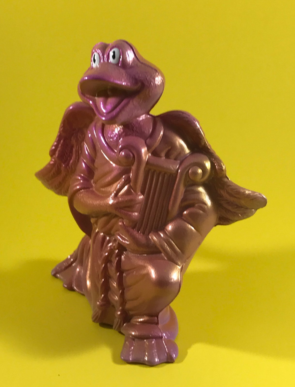 Translucent pink and gold harp frog