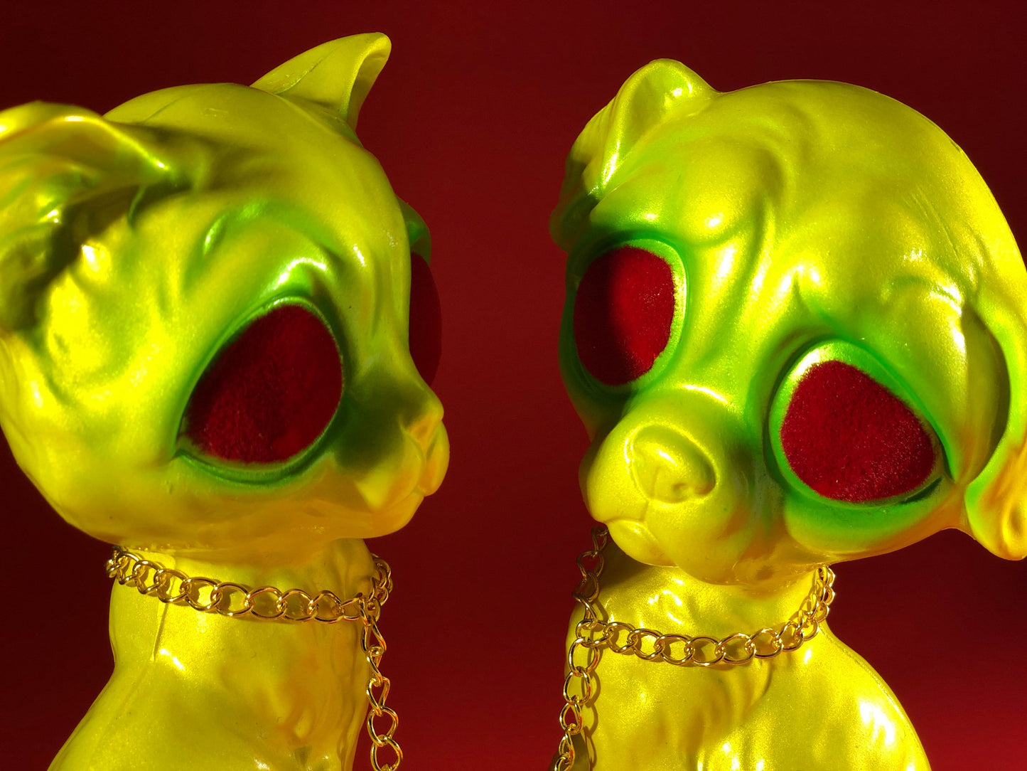Sad dog, Sad cat chained together. Yellow and green with red flocked eyes