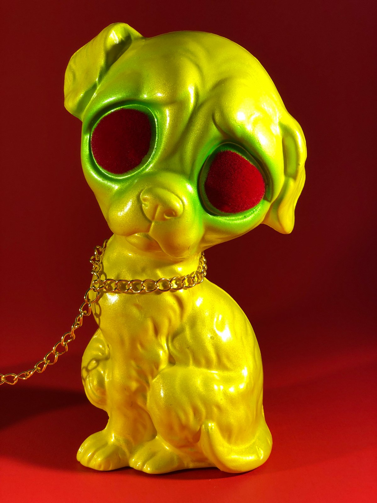 Sad dog, Sad cat chained together. Yellow and green with red flocked eyes